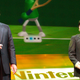 Reggie and Iwata play the Nintendo Wii on stage.